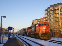 CN 5782 & CN 2256 lead CN 401 past St-Lambert Station just before sunset. CN 401 would meet counterpart CN 400 a bit further ahead on the Victoria Bridge.
