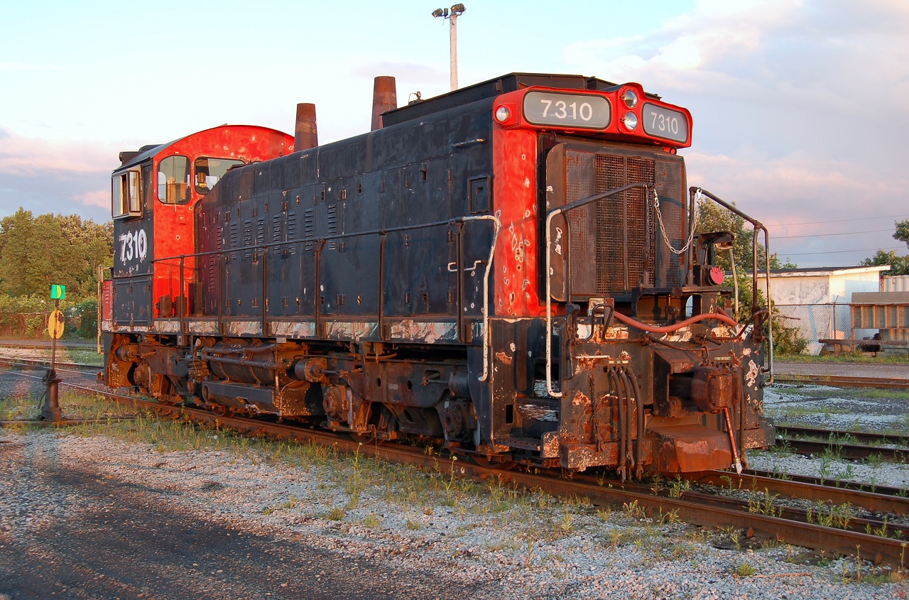 Ex CN SW1200RS 7310 sits in the CN "C" yard at Sarnia, Ontario. Curiously the CN logo has been painted over but no other reporting marks are visible