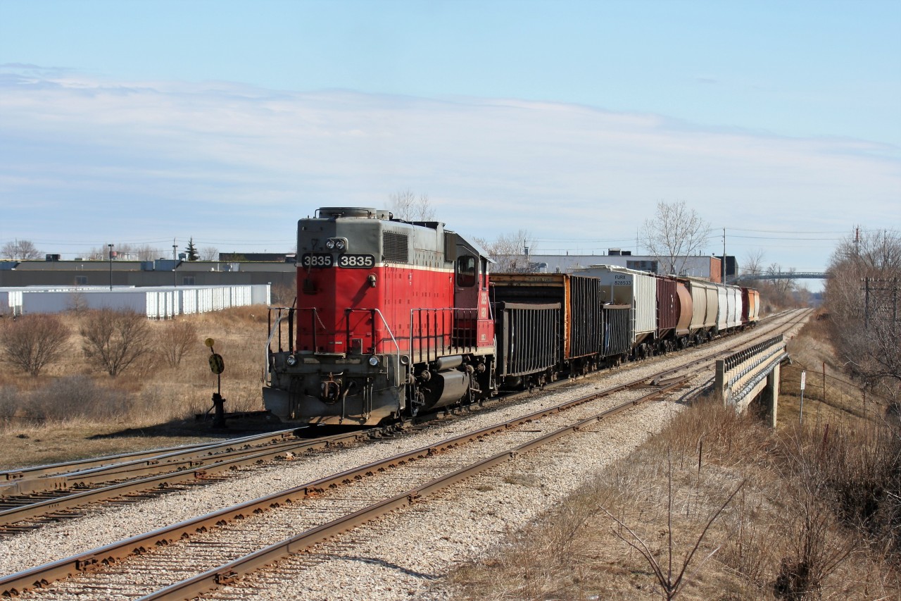 GEXR train 580 is seen returning from Guelph at the east end of the Kitchener yard with GP38AC 3835 leading 14 cars meeting a stopped 432. Train 432 was waiting in the siding for 580 to clear into the yard before it could start its work at Kitchener.