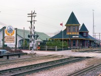 Two stations in one!!  Not seen very often. This image from back in early 1980 shows the original Great Western Station, built @1855, in behind the classic Grimsby CN station that was constructed in 1902. The GWR station, one of the oldest in Canada, now is home to Forks Road Pottery, and has been under restoration by the owners for some years now. Prior to that, the building was utilized as a fruit storage area, track leading to the building was only removed just before this photo was taken. Out front on what is the current CN Grimsby sub once stood this highly photogenic building, which was the pride of town until its demise in a disastrous electric fire on the last day of 1994.
In this photo we see the station just at the beginning of its' life anew as the cornerstone of a planned "Village Depot", (1979-1994) a sort of trackside plaza. "Keystone Kelly's" became the restaurant of note that occupied the close end, and a 'Rockin' Robin' banner was displayed upstairs on a turret signifying the DJ entertainment that was the highlight of the weekends. A row of rail cars to be used as commercial establishments was situated on the west end of the building, just visible in this photo is a caboose in prep. When the station burned, an old boarding car was in place there. Other cars, representing failed ventures over the years had been taken out. Half wood barrels with colourful flower displays in season added to the charm. It was an interesting adventure, but perhaps a little before its' time. The idea of historical districts and folksy neighbourhoods had not quite caught on yet. I remember buying ice cream and hot dogs there, and do possess souvenir salt/peppers with the station logo on them, so there was a snack bar and gift shop among other things.
Now, there is a mostly disused modern VIA kiosk where the flagpole and evergreens were. VIA spent the big bucks to put up one of those huge VIA signs, and then discontinued service. Figures. All there is now is the daily AMTK Toronto to New York City and return. However, all-year GO will become part of the scene soon, currently it is just running to the Falls in summer. But it won't stop at this location. A new station will be built a couple miles west of here at Casablanca Blvd, as far as I know.