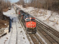 CN 435 with CN 2245 and IC 1008 (in CN paint) head west under welcomed sunny March skies at CN Snake.