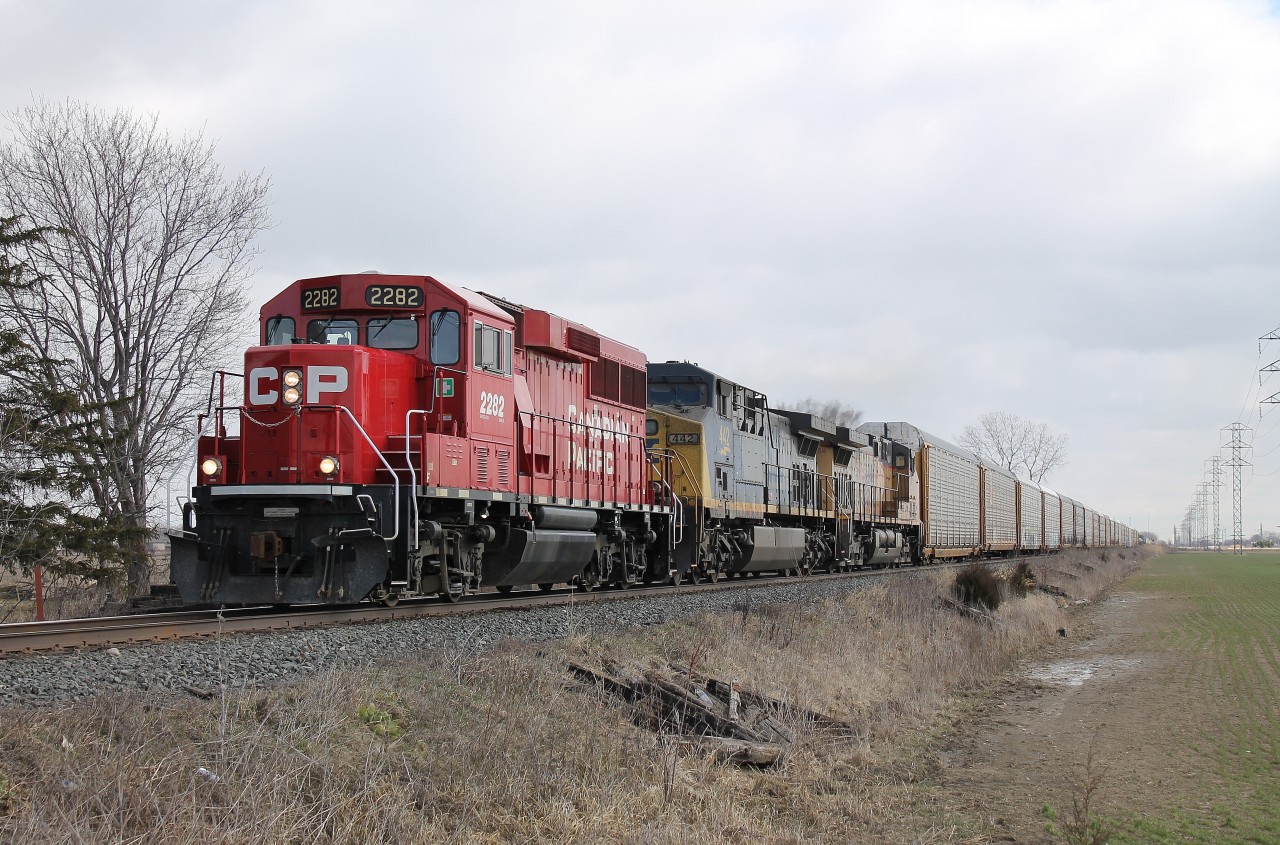 CP 141 travels through the sleepy town of Belle River on a Friday morning. 141 has an interesting assortment of power ranging from an uncommon leader on a long haul mainline freight to a pair of American units from CSX and UP.