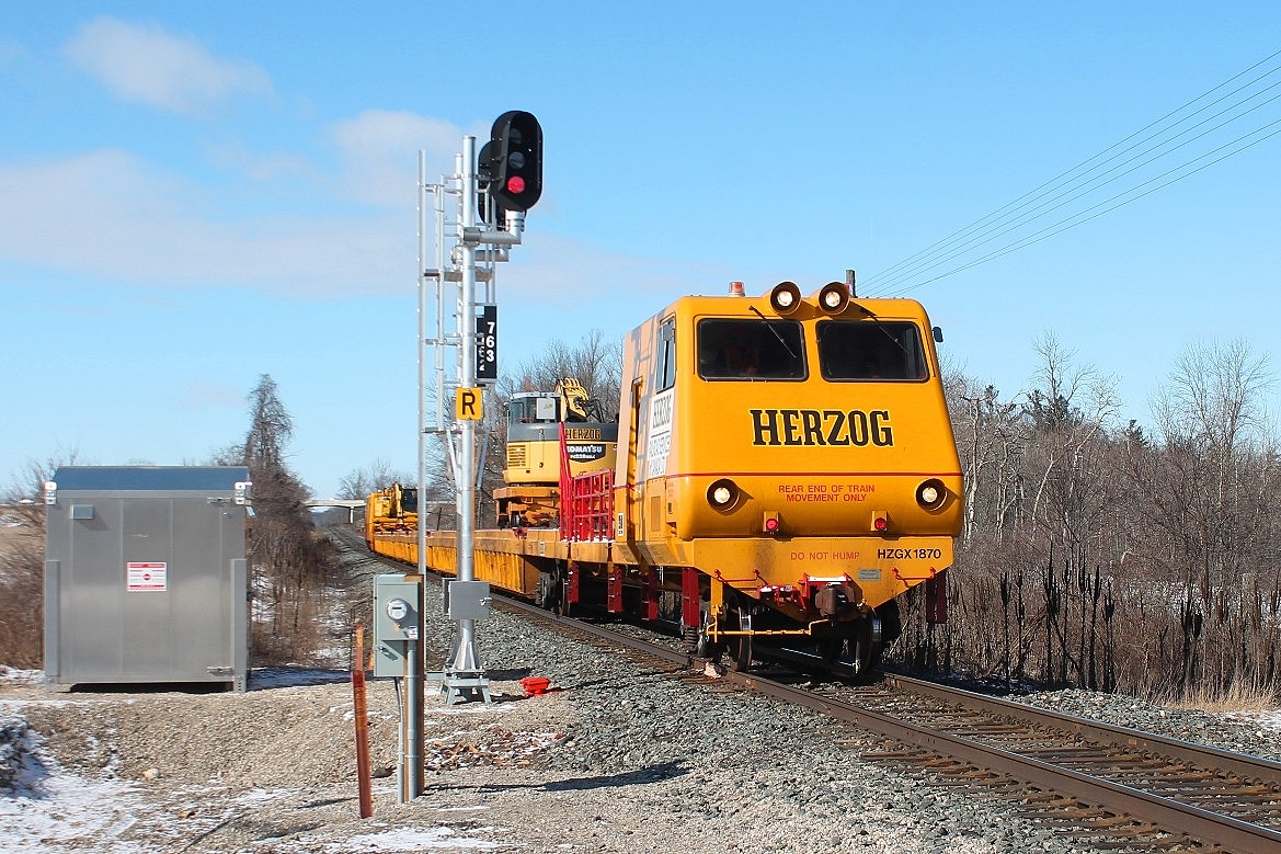 The first outing this year to Gobles Road crossing to the west of Drumbo I was surprised by the reallocation of the signals. The eastbound Herzog is on it's way to Wolverton.