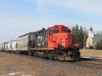 The eastbound local stopping to switch cars at the Stubbes' Cement plant next to the crossing.