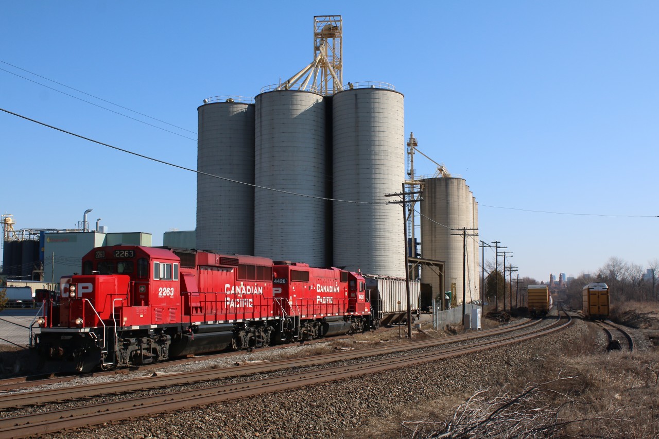 It is quite predictable these days that CP local T14 will work the large Ardent Mill facility in Streetsville on Mondays. This Monday was no exception with the train lifting four empties and dropping off only a single loaded hopper. With the retirement of the old GP9Us and the GP40s power is always a mix of GP20ECO's and GP38's, this days power was one of each. The rest of the trains consist is seen holding the north main track, while a bad order Union Pacific auto rack awaits attention on the currently unused ADM spur to the right.