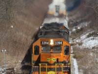 For those who had had the opportunity to stand on the old steel road bridge in Limehouse during the passage of Goderich Exeter train 431, they know a photo can never do justice to the sight and sound of the train digging into the beginning of the climb up the Niagara Escarpment. Today would be no different, and the amount of haze blurring the background illustrates that. A day of above freezing temperatures has melted a lot of the snow, accumulated over the past few days. The advance signal to CN's Halton subdivision can be seen blurred in the distance.