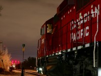 The headlight of CP ECO GP20 2263 illuminates the road ahead as the crew keeps warm in the cab after switching the industries around Streetsville under the cover of darkness. The trains typical schedule is completely out of whack this day for some reason as the train waits on the old Owen Sound subdivision at 3:30am, on the yard lead at Streetsville. The regular schedule finds T14 arriving in town in the mid morning hours. The trailing unit suddenly comes alive as a foreman clears the train through his limits at Thomas Street, and within a few minutes the train will begin its journey back to Toronto yard.