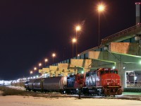 This scene would've looked very differently as recently as 17 years ago since the Gardiner Expressway came to an end at Leslie Street, a fair distance east of here. The bridge columns would've extended beyond what the eye could see here. In recent years, it has also come into question whether Keating Yard and the Portlands Spur itself may become a thing of the past as well. At this moment, it still exists and the City of Toronto appears to maintain intentions to keep the line open despite the Ashbridge's Bay treatment plant now being the sole reason this line continues to see shiny rails. The track south of the treatment plant that goes west to the docks also still exists, but hasn't been used in quite some time. Currently the tracks at Logan Avenue are ripped out due to a sewer project and apparent intentions to relocate the crossing. So for now, the Portlands Spur is inaccessible east of Keating and probably will be for some time. Even the Port Authority continues to maintain the track area around the docks, though nothing comes. Why the spur is even maintained at all is questionable as the cost to keep it open most likely far outweighs the savings from running chlorine tankers in and out by rail instead of by truck to the treatment plant. With the dock in Oshawa opening soon for rail service, it's debatable if maintaining track to Toronto's dock is even viable.
<br><br>
For some reason CN 543 decided to show up to Keating yard (runaround is probably a better term), probably to move stored cars in and out of the Lower Don yard tracks just west of Keating. With only four cars, and no chlorine tankers, it is evident they didn't come down here to switch the Ashbridge's treatment plant. Oakville yard based 4777 and 7080 are the power. Time will tell if the effort to keep this line open will continue. Although it appears Ashbridge's runs will continue as soon as the Logan Avenue crossing is restored. The next two weeks after this photo saw no 543 come down here, so this particular 543 must have come down to switch the Lower Don tracks. For now, CN operations in Toronto east of Yonge Street should be focused solely on CN 546, which is about all that's left in the city's legal limits besides the currently sporadic 543. West of Yonge Street is a completely different story of course, with switching operations at Mimico, Lambton, Etobicoke North and Downsview still going strong.