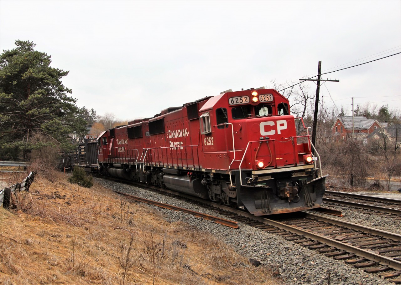 Approaching what could be one of the worst uneven road crossings around, the rail track train with a pair of SD60's in CP 6252 and CP 6251 bank their way towards the Guelph Line crossing surrounded by the new rails it dropped last week.