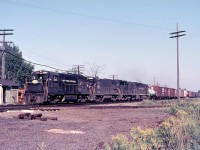 Only a few months into the Penn Central merger, subtle signs of the change are noticeable on the third unit, which appears to be re-numbered. Power on this westbound PC freight are "NYC" U25B 2506, U30B 2878, a GP35 and GP40.