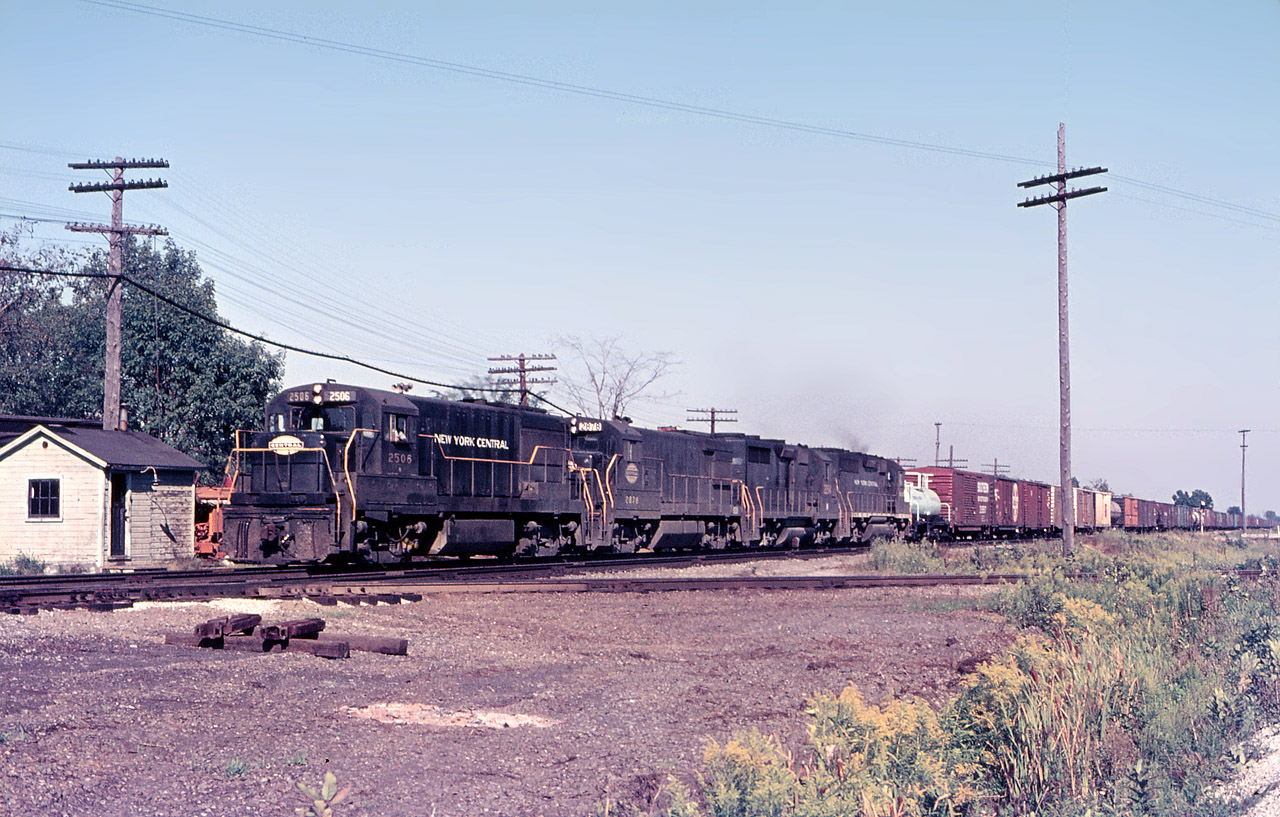 Only a few months into the Penn Central merger, subtle signs of the change are noticeable on the third unit, which appears to be re-numbered. Power on this westbound PC freight are "NYC" U25B 2506, U30B 2878, a GP35 and GP40.