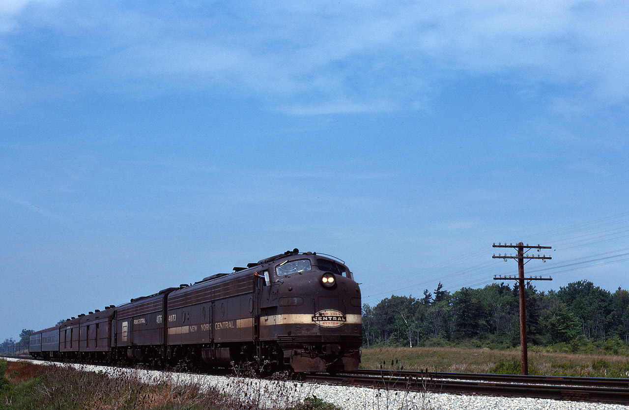 Merely a shadow of it's prior glory, Penn Central train No. 50 a midday Detroit-Buffalo run via St. Thomas, is gliding up to the Home signal at Canfield with E8's NYC 4073- PC 4076 and only 4 cars. Amtrak is less than 9 months away from startup but PC has nearly thrown in the towel on this service. Turn the clock back just 2 or 3 years and this train would be upwards of 10 cars.
At least the Engineer is having a good day !