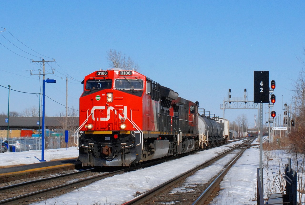 CN-3106 lead loco plus a second CN loco pulling a convoy of freights cars near 7,200 feets long going direct to Toronto on CN Route X-321