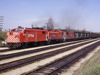 CP 4050-8431-4466 on train ‘OOD’ at Guelph Jct May 16/73.
The 'OOD' ( Oshawa Oakville Detroit ) was a dedicated auto industry train that could be counted upon to show up in the same timeframe every day with whatever power was necessary to keep it on schedule. This brightly painted lashup was irresistible as it worked throttle wide open to make the top of the grade with 76 cars.
