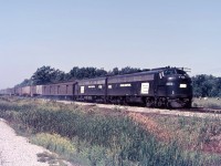 In September 1968, just under 3 years prior to Amtrak, Penn Central midday train No.50 was traversing the Canada Division between Detroit and Buffalo. E8’s 4065 (exNYC) and 4248 (exPRR ) have an assorted consist on their drawbar. The containerized cars are NYC-designed FlexiVans and many of them had steam trainlines so they could be expedited on the faster trains. There are three such flatcars today, in between the 4 baggage cars. And there appears to have been a heavy brake application coming up to the diamond, as the brake shoe smoke is kicking out from beneath the train. Train No.50 will make a scheduled stop at Welland in under 20 minutes, immediately after crossing the Welland Canal drawbridge which is still in use today by Trillium Rail.