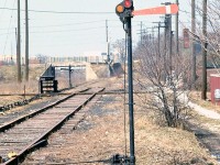 Manually controlled semaphore signals protect the junction of this spur to Riverside that branched off from PC's (ex-NYC) CASO Sub line and crossed the Essex Terminal Railway, in Windsor ON in 1974. Note the outdoor interlocking lever controls near the diamond, not protected from the elements by any shelter or awning.
<br><br>
According to track diagrams, this was the "Windsor Star Lead", a spur from nearby Van de Water yard that ran west to service the Windsor Star, crossing the ETR's line at the manually interlocked diamond here, a stone's throw from the Detroit-Windsor tunnel entrance (the interlocking is barely visible in the upper right of <a href=http://www.railpictures.ca/?attachment_id=14850><b>this photo</b></a>). It continued to be in use by CN after Conrail sold off the CASO Sub in the 80's.