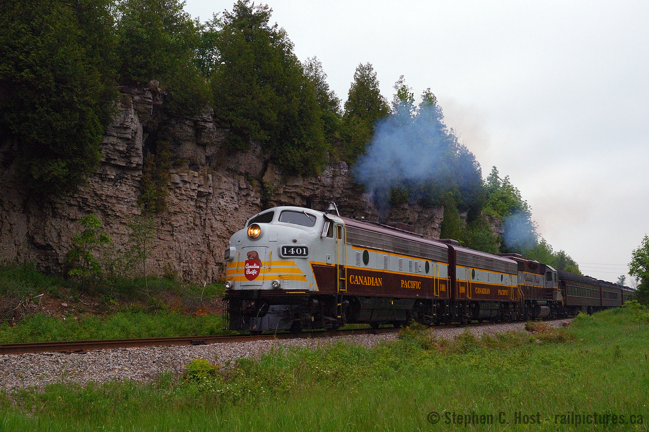 I was a very spoiled Railfan in the early 2000's. Little did I know how good I had it. SD40-2's were on just about every other train, the GEVO invasion wasn't on the radar - EMD's were everywhere. We had annual visits from the Royal Canadian Pacific and/or CPR 2816, heck 2816 was in Toronto just one week later on June 12 2004 and I went for a ride from Aberdeen to Welland. However, the one thing I didn't have much of was photography skill. Most good photos I managed to take in this timeframe was mostly beginners luck. I had yet to find my footings, and while I knew what looked good, I just lacked the experience to find a great photo location and compose it properly. But sometimes, just sometimes I managed something good. This photo is surprising for many reasons, that I chose to shoot RAW - which meant I KNEW it was good - that I composed it without any weeds or other obstructions, and that it is in fact located in Guelph - what you see is the dolostone cap of an ancient seabed - in essence it's the same formation you'd find in the Niagara Escarpment but in an unusual location. With OSR Employee Brad Jolliffe piloting a CPR Crew, a dozen of us are standing on the ground, everyone except for me a patron of the  train that day - for when the train backed up to pick up their passengers, I was the sole photographer left standing, no other local railfans were present, to my amazement. If this happened today... could you imagine the crowd? We were all spolied back then and I think this tells the story to why.