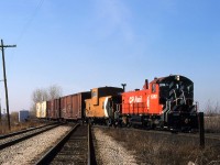 
CPR had a Roadswitcher based at Chatham in the 1980s and as required, 3 or 4 days per week, it would make the trek westward to switch customers at Tilbury ( Hunt-Wesson Foods) and perhaps as far as Saint Joachim ( although I have no first-hand knowledge of that). The engineer on this job, a nice man named Maurice (---) lived beside the C&O Sarnia Sub. in Wallaceburg. He would always give us a hi-ball when we went through that town. Anyway, here's his job returning east at the diamond of the CN Chatham Sub. just west of CP Ringold siding near Dillon Sideroad. This is pretty much the normal operating procedure when heading home to tie down, having the caboose (van) next to the engine. The last car is definitely from Hunt-Wesson, one of those SOLID COLD reefers probably with frozen peas or french fries. The pole lines are still in place, the Chatham Sub. is still 2 tracks and 1268 has yet to receive ditchlights. This engine still exists today, living a sheltered life at Unimin Corporation in Hephzibah GA.