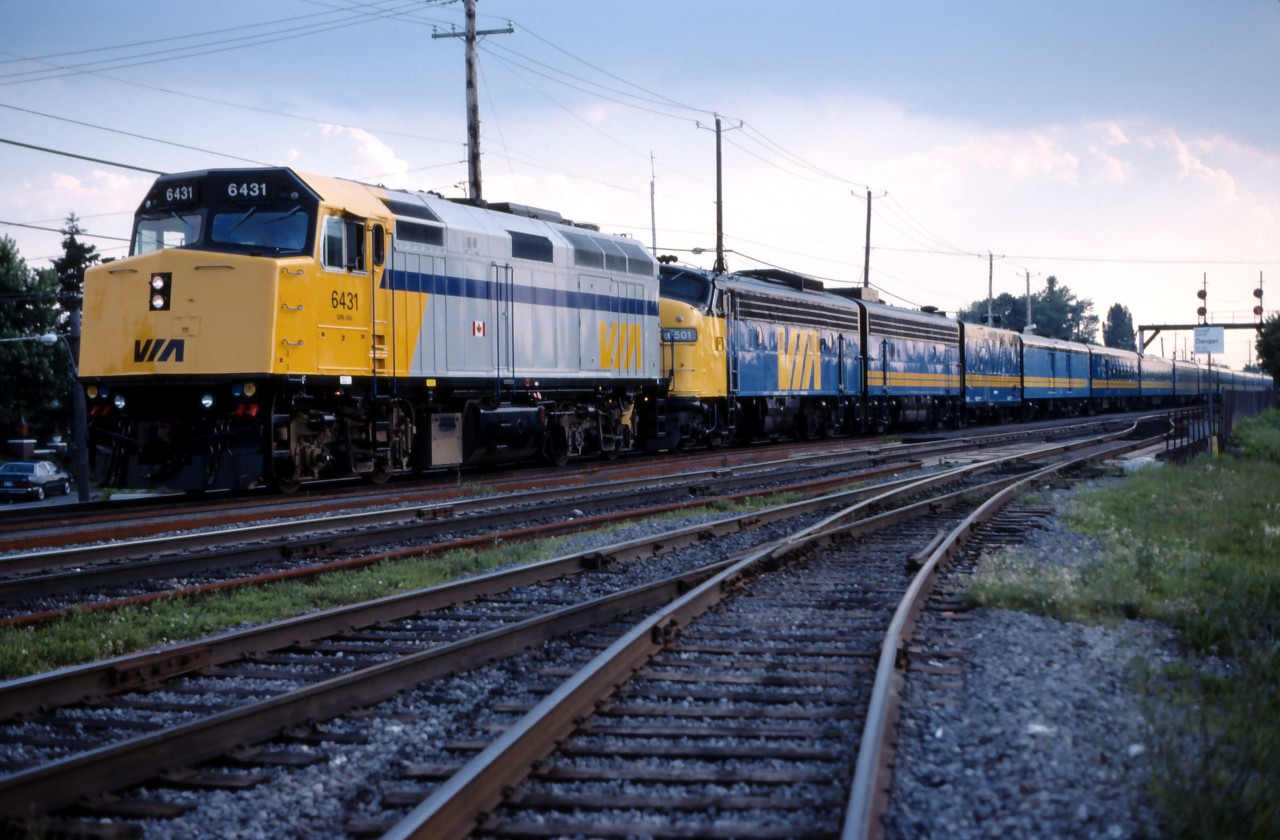 VIA No. 14 pauses at St. Lambert, barely into its 651 mile/1047 km journey to Moncton. At the time, the "Ocean" carried equipment for the "Chaleur" as far as Matapedia, Quebec where it would be set out for conveyance to Gaspe. Halifax service was provided by the "Atlantic", train No. 12 which would pass through St. Lambert 40 minutes later, operating over CN tracks to Sherbrooke, then CP tracks through the State of Maine, and returning to CN rails at St. John. The F40-cab unit consist was typical prior to the January 1990 VIA cut-backs which would put all three daily trains onto a three day per week schedule.