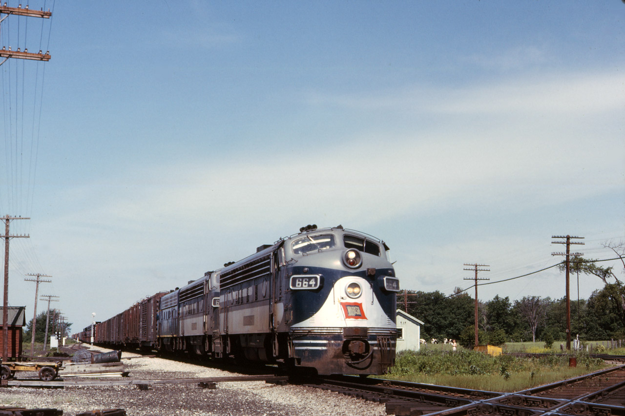 Wabash Train 28 is eastbound at Canfield Junction in June 1964 with a classic trio of GMDD London-built covered wagons, lead by F7A 664.