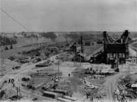 A tank engine rests near a few others at what appears to be a gravel plant. This unlabeled photo was in a group of photos taken by my Grandfather during a time he was working on the powerhouse for the Churchill grain elevator. The topography is definitely not of the Churchill area. It took a while to determine where this shot was taken and this is the best I can determine. Presumably stone from this location was used for the construction of the line to Churchill and the elevator as well. A generating station was built on this site in the 70's. Photo by my Grandfather with editing assistance from the moderators.