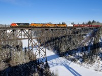 CN C44-9W 2566 teams up with BNSF ES44C4s 8355, 7190 and 4256 leading CN detour train F30541 05 across the Pembina River between Entwistle and Evansburg, Alberta. This is BNSF's G AVIKAL9 05 detouring from Noyes, MN to Vancouver, BC due to ongoing issues on BNSF's Hi-Line Subdivision in Montana.
