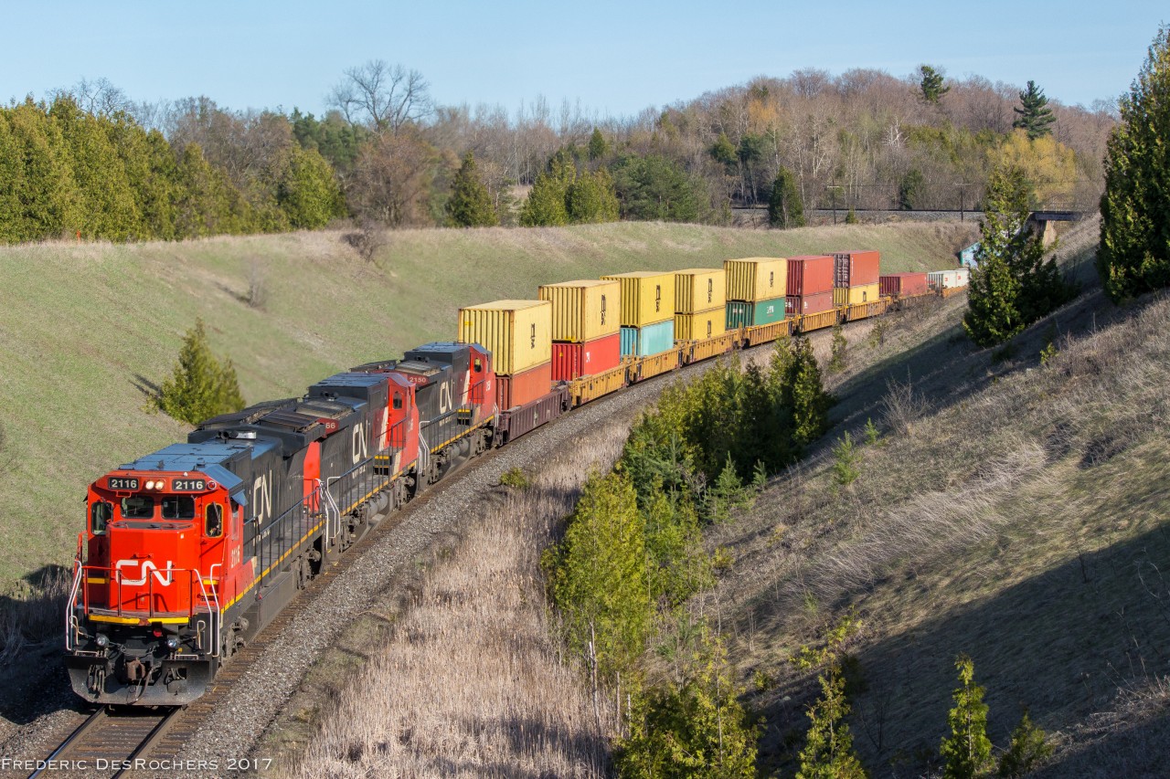 A trio of Dash 8 gracefully bring 149's train up the hill through Beare 

CN 2116, CN 2166, CN 2150