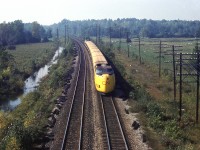 An Ollie McKee photo.
Not much to go on from the slide itself but with a little help from people that know the railroad, this appears to be at mile 101, eastbound, off the Regional Road 1 overpass. Given that Mr. McKee was a Brockville resident, this would be within his ' territory '. If anyone has a different opinion, I'd be happy to have the Editor make a correction. 
In any event, a good overhead view of the yellow worm.
