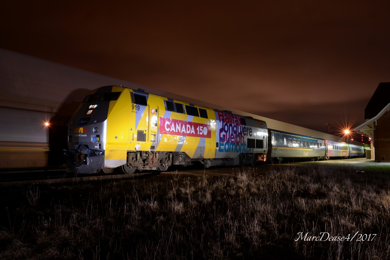 VIA 84 waits to depart Sarnia with brand new wrapped 919 as an incoming freight streaks by.