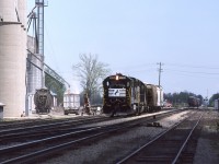 Norfolk Southern and Norfolk & Western before that, and Wabash before that, all enjoyed the perks of serving certain customers along the CN Cayuga, Paynes and Chatham Subdivisions. While we were living in Chatham, I tried to find out when NS would be switching the elevator at Thamesville ( in 2017 known as AGRIS Co-op). The work was always done by westbound train 27 who would cut off the rest of his train east of Highway 2 and then perform a series of run arounds in order to accomplish the switch. After having pulled and respotted the customer, the power is about to tie back onto the outbound cars and then shove further east to put his train back together. The classic CN Thamesville station, although obscured by the movement, is still standing in this image. I never saw NS switch the other facility ( seen here to the left of the engines ) so obviously CN did that chore.