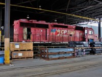 One last look at the CP Rail System emblazoned flank of SD40-2 5857 before it heads out to be scrapped. In the front of this photo are various GE cooling system components including 2 stacked radiators.