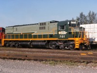 A sunny morning at Quesnel BC as the regular symbol freight "VO" pauses in the siding. Engine 701 is sporting fresh paint after undergoing major overhaul. White flags indicate "run extra" northward from Williams Lake to Prince George.  The crew will take rest at Prince George and then return to Williams Lake, departing Prince George later in the evening, most likely on #38 the OV symbol.