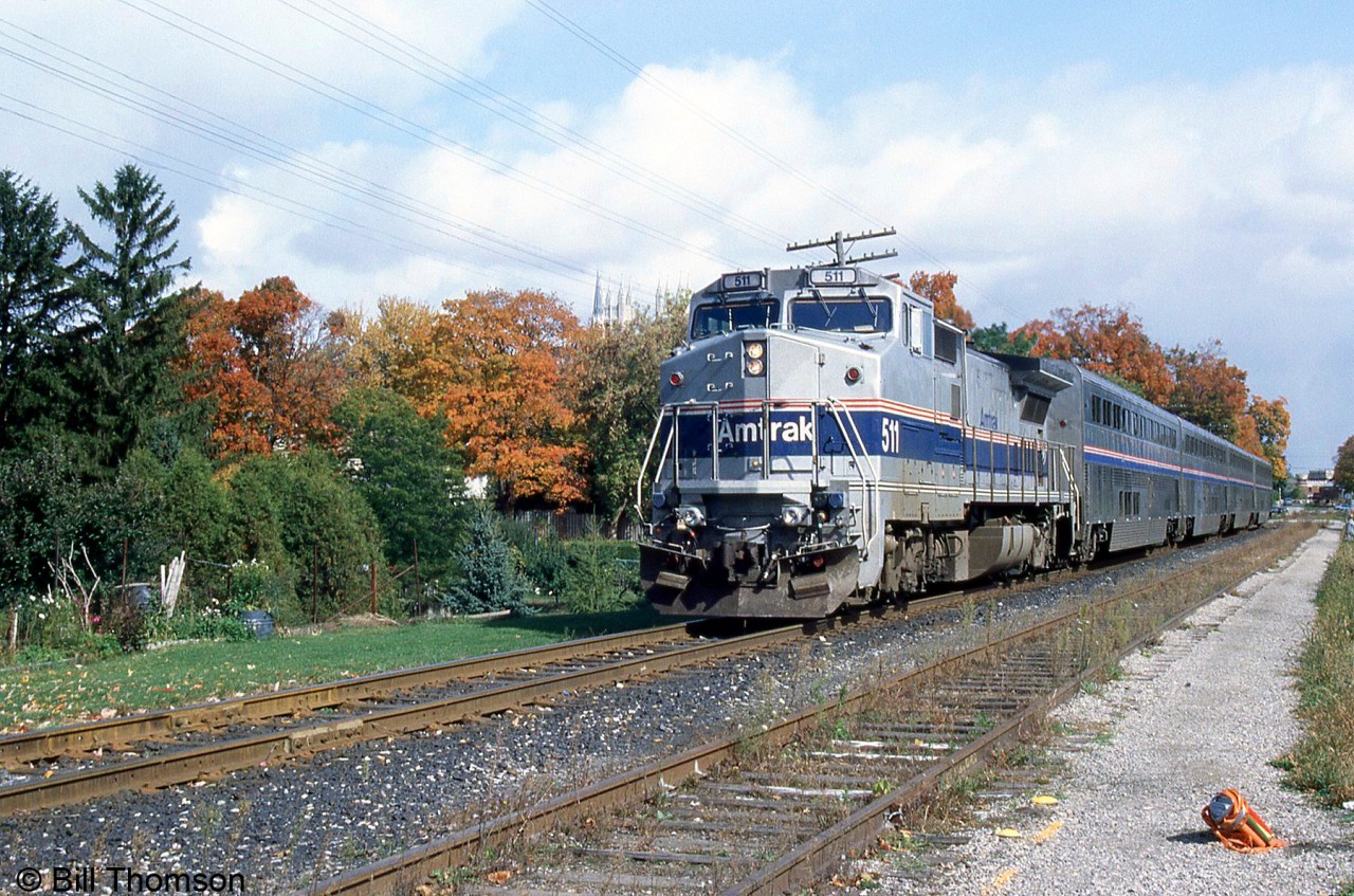 Amtrak GE B32-8 511 leads the "International" on the GEXR (former CN) Guelph Sub, leaving Guelph past the local fall colours in October 2000. It wasn't long before this run was abandoned a few years later.