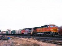 The roulette wheel keeps on spinning, as a pair of BNSF GE's 883-829 are on the point of NS St. Thomas to Buffalo train 328 passing through Brantford on a cool November morning. The existence of trains 327/328 on the NS ledger was to provide timely service for Ford's Talbotville plant. But long before the auto maker built that facility, predecessor Wabash RR had procured other on-line customers. Those covered hoppers may have come from one of several elevators along the former Paynes or Cayuga Subdivision's, or from the Thamesville elevator on the Chatham Sub.