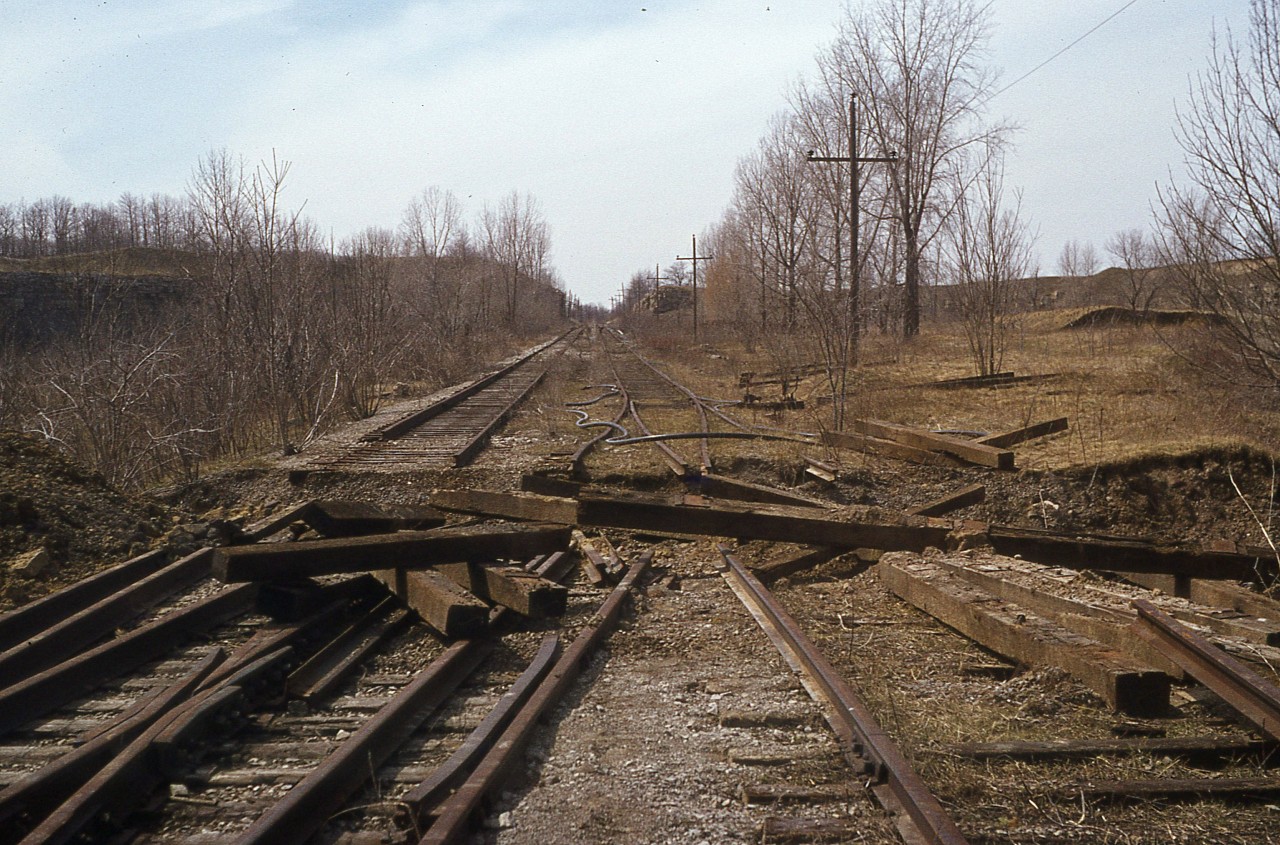 Over the past while we have seen photos on this site of all things Canada Crushed Stone, that once prominent company that was a landmark on the hillside overlooking Dundas. We've had images of locomotives, facilities and some related business trackage. This image is a photo of what was once the CCSL "mainline", the electrified track from the quarry itself by Highway 5, by which materials were transported to the breakdown operations overlooking the CN Dundas Sub. Loads one way, empties the other. The operations closed down in late 1973 I believe, and this image is from a year and a half later, and it wasn't long before all track was pulled up, leaving the area almost as pristine as it was to begin with.