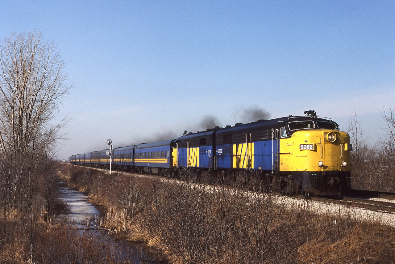 Knowing that VIA trains 72 and 74 had older power, and not the dreaded, new F40's, I went trackside from the house on a beautiful Tuesday morning in early March. In Canada's ' Sun Parlor ' you can expect this type of weather at this time of the year. With 8 coaches and a full baggage car behind them, FPA-4's 6782-6793 bring train 72 across the CPR Windsor Subdivision, just a few minutes from their scheduled station stop. Even on a Tuesday in March, this early morning run warrants a big consist. It was probably well-filled going west the night before as train 77. 6782 went for scrap, but 6793 was initially operated as Western Maryland Scenic RR " B&O 893" before ending up on the Grand Canyon Rly, renumbered to 6793 again. It may or may not be in service.
