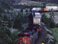 CN train #101 led by SD60F 5554 approaches the diamond at Coniston on its way to western Canada. The rocks around Coniston offer lots of potential photo angles if you are willing to walk and climb a bit. 