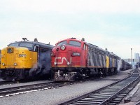 Back in 1987 VIA had 5 departures each way between Windsor and Toronto. There were 3 morning trains, one at mid-afternoon and finally one a 1800. Number 70 had already left the station at 0600. Next out would be CN 9175, with VIA helpers 6767 and 6553 with train 72 at 0900. The final morning departure at 1105 will see VIA 6765 in charge of train 74. Today there are 4 trains each way.