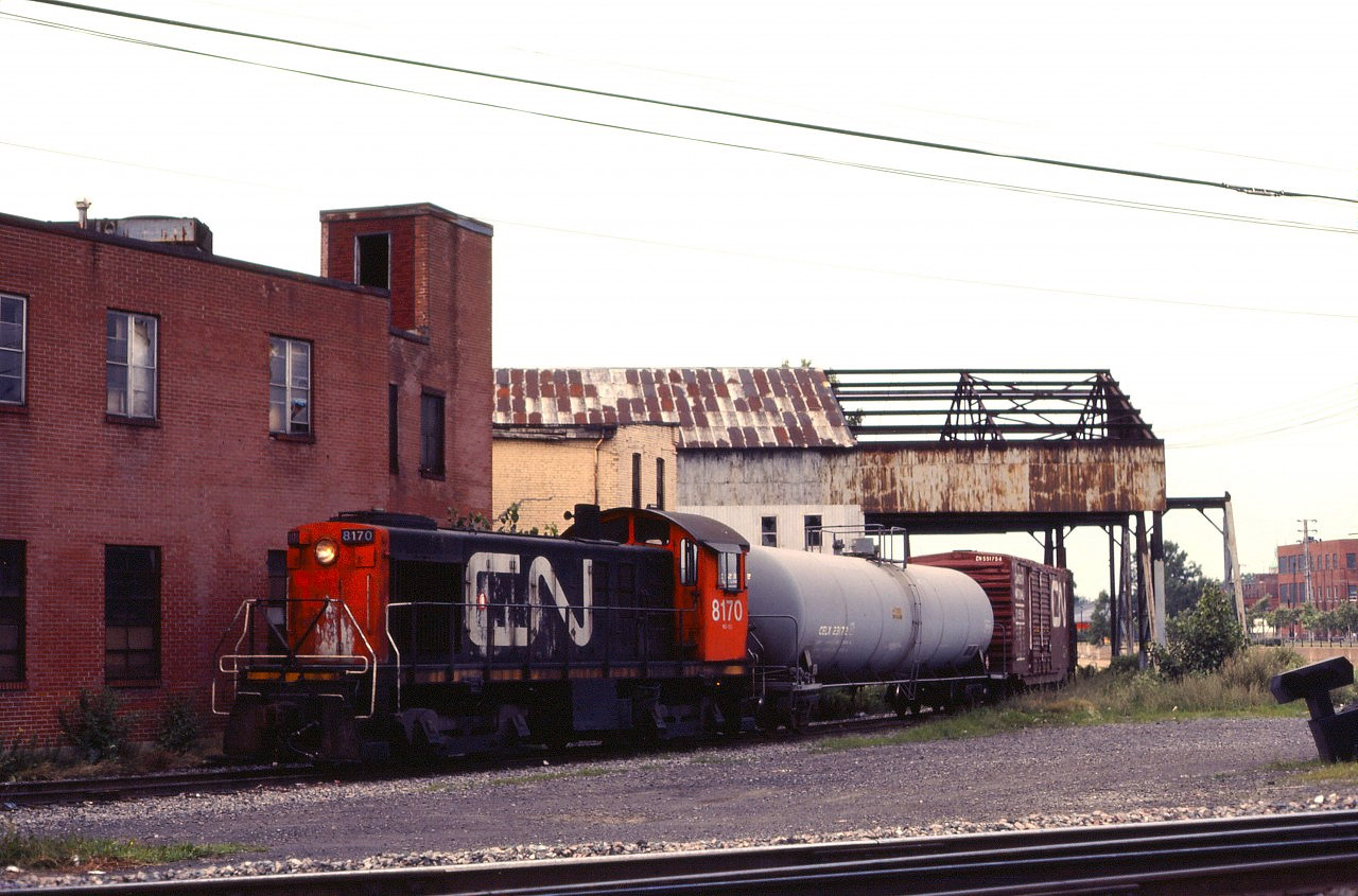 "Back in the day", much of Montreal's industry was located along the banks of the Lachine Canal and served by both the railway and the Canal. CN had a spur on the west side which ran in both directions from the Montreal sub main line as well as a small support yard just west of St. Ambroise street. (CP had a similar spur on the other side.) On a hazy summer evening, we encounter an old friend coming off the Canal Bank spur--CN S4 8170 which was based in Hamilton for many years. Alas, she will be retired within a year or so.