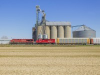Ever since moving to Chatham, there have been many new places to explore for this rail fan. One of my new found favourites is this picturesque little setting on the Windsor Subdivision. Well, more so luck than anything as I chased this train here from Tilbury, unaware of it's presence until the outskirts of town.
<br>
Nonetheless, here on a wonderful and warm Sunday afternoon at the siding called Haycroft, this westbound freight hauls it's load past the Agris silos. 
