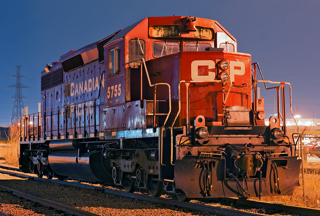 After working CN 546 at Oshawa, I decided to venture out to the interchange track where CP 5755 sits silently, her fate sealed with the scrapper at K&K recycling in Pickering. Built in London, Ontario by General Motors Diesel Division of Canada in 1975 for the CPR on frame A3351, she has lived a long service life of 43 years. Taken on CN property by a CN employee with PPE gear on.