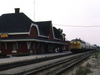 
VIA's criteria for motive power relative to train length, at least in the Quebec/Windsor corridor, was 1 engine for up to 6 cars, 2 engines for up to 10 cars and 3 or more engines for longer trains. On a quiet Sunday afternoon train 72 from Windsor is gliding to a stop at the recently repainted Chatham station. FPA-4 6785 is sporting a pair of CN-style clip-on ditchlites as it brings 6 cars to the platform for a small group of revenue passengers. Just prior to repainting this station was grey, but I preferred this colour. Even the attempt at some horticulture was a welcomed touch.