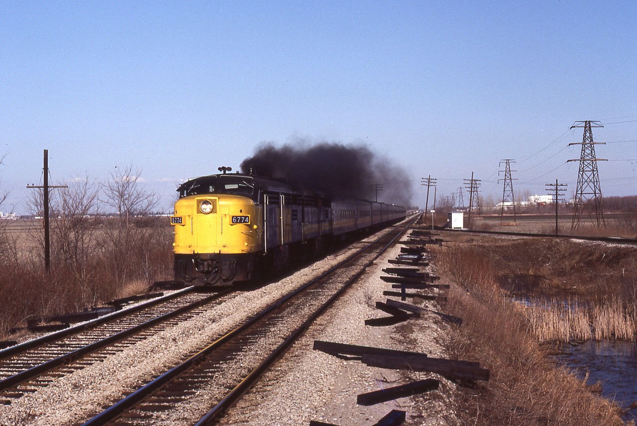 April 1, 1984. ( the day singer Marvin Gay died). But for me, just another day of hanging out at the CN + CP diamond west of Chatham. I lived on the near west side of the city, so it was only a 10 minute drive to get here. I only made the effort on days that were sunny and clear from humidity. I would also only spend time when certain passenger trains were scheduled because I knew the F40's were going to be purchased, and I wanted to get the cab units in their twilight. On this Sunday, I waited for train 75 to appear in the distance, then I hastily climbed to the first-level perch of the eastward Absolute signal and grabbed this image as the A-B pair of MLW's throttled up again.
