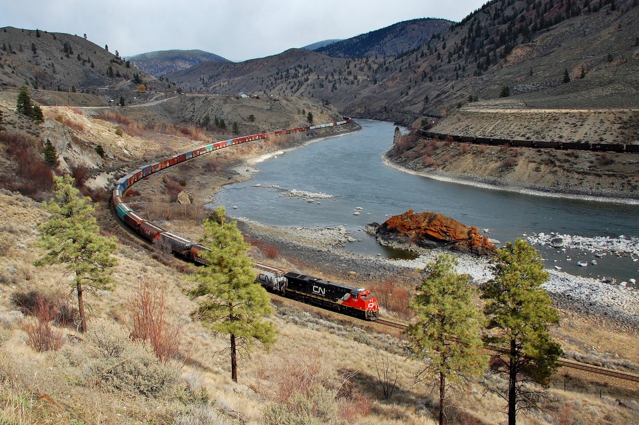 CN 3089 is approaching Spences Bridge at the head of a westbound mixed freight while a CP coal train is going east on the opposite bank.