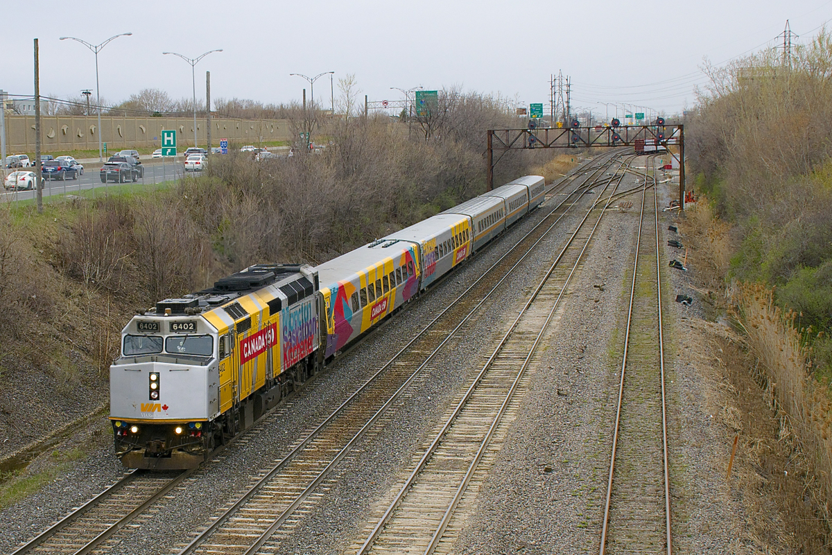 Three wraps are up front as VIA 62 passes the eastern entrance to Taschereau Yard (you can barely see the tail end of CN 527 in the distance) with VIA 6402, VIA 3476 & VIA 3357, followed by three rebuilt LRC cars.