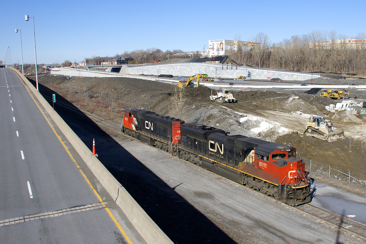 CN 372's power (CN 8011 & CN 5679) head east on track 29 (the only track left from what was Turcot Yard) to pick up CN 2921, which was the DPU on a grain train. At left are the eastbound lanes of highway 20 and in the distance is CN's brand new right of way, including a signal bridge. CN's main line is currently to the left of the highway here, but will be moving to the new right of way due to infrastructure changes in the area.
