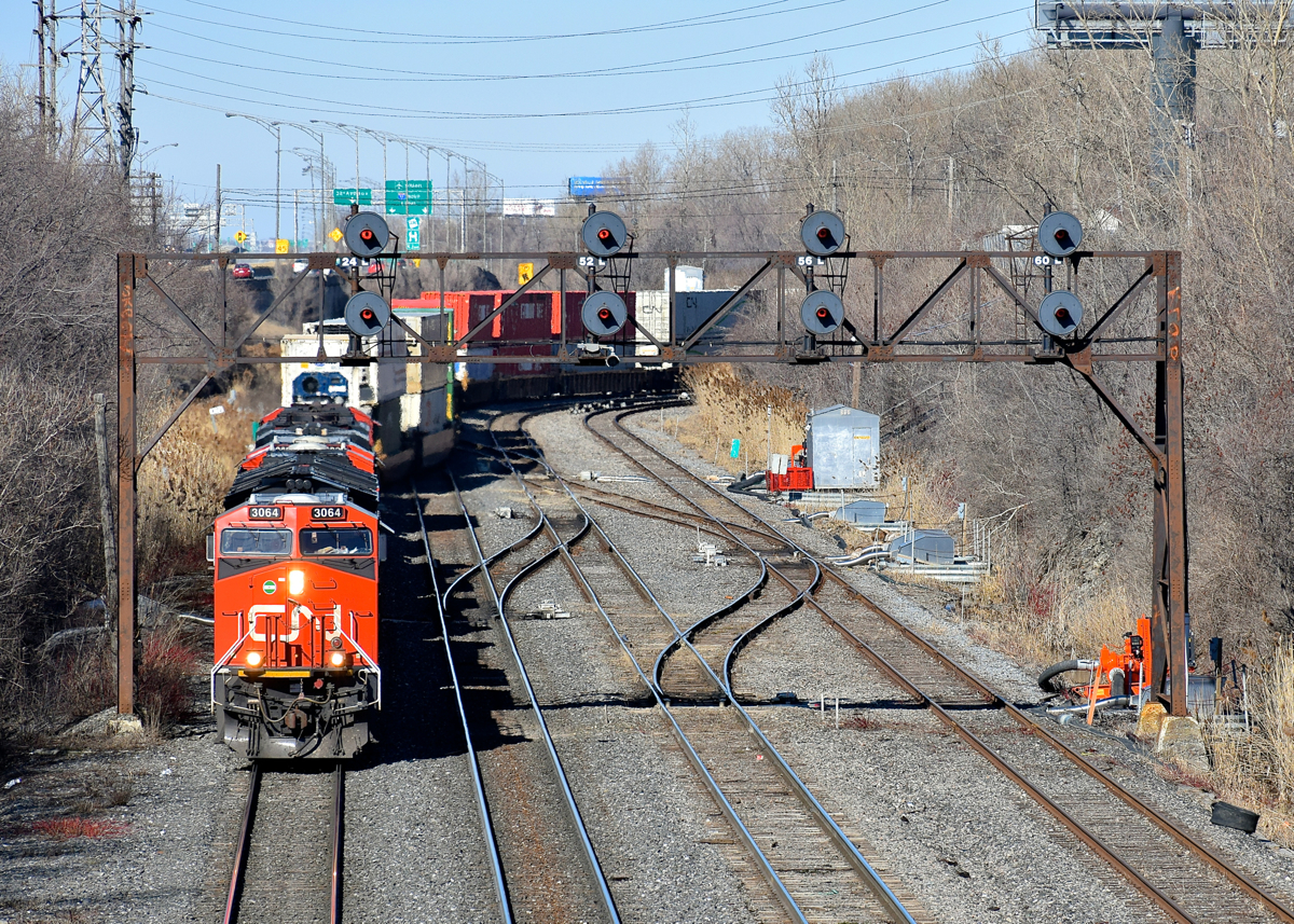 CN 3064 leads three other AC units (CN 3021, CN 2820 & CN 8100) as CN 120 exits Taschereau Yard, crossing over from the north to the south track in the process.