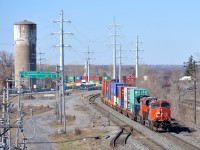 CN 108 rounds a curve through Sainte-Anne-de-Bellevue with CN 2331 & CN 3067 and a 488-axle train as it enters the island of Montreal.