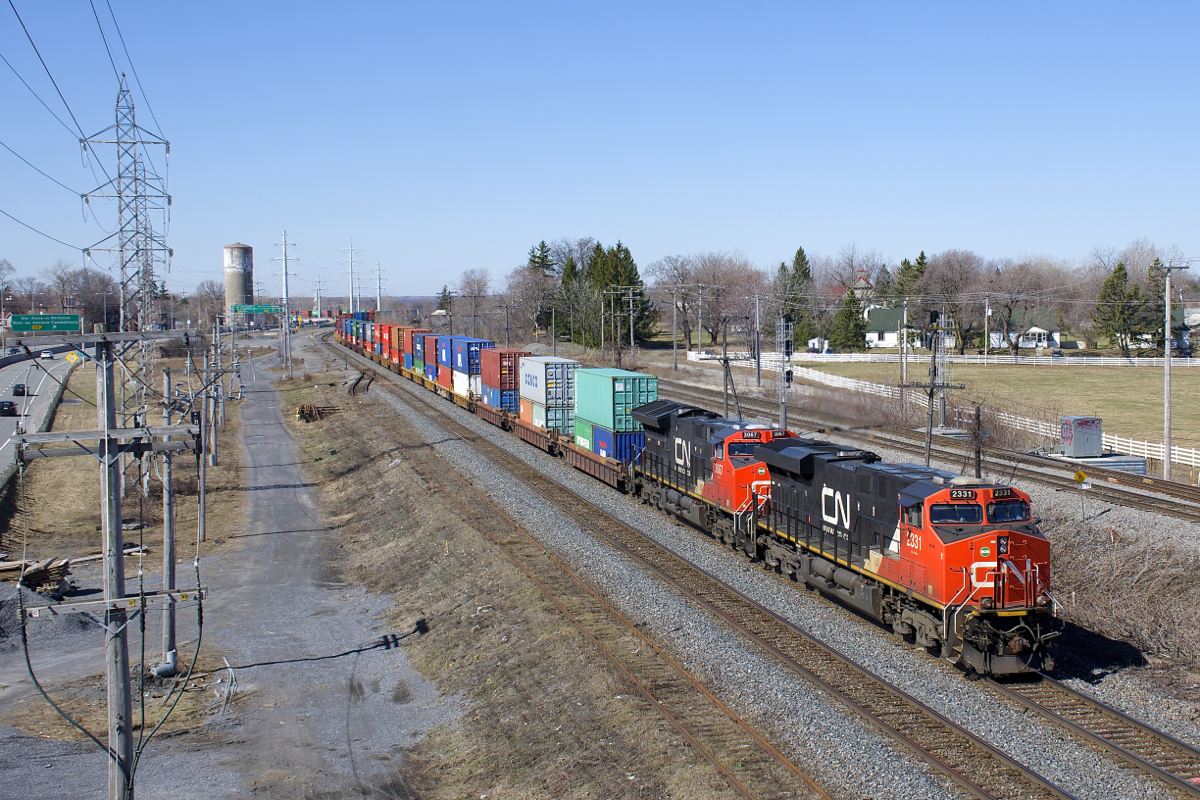Now running through to Montreal from Thornton Yard in Vancouver (and bypassing Brampton Intermodal Terminal in Toronto), CN 108 is an addition to the intermodal trains that can be seen on CN's Kingston Sub between Toronto and Montreal. Here it passes through Sainte-Anne-de-Bellevue with CN 2331 & CN 3067 and a 488-axle train.