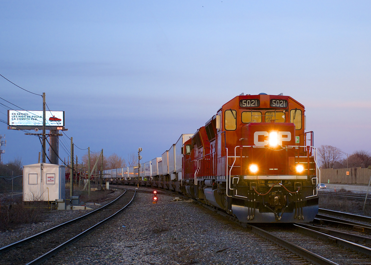 It's the blue hour as CP 133 approaches Lachine Station with a pair of SD30C-ECO's for power (CP 5021 & CP 5005), a welcome change from the usual GE's. Very barely visible at left behind the power lines is CP 118, temporarily heading west as it sets off part of its train in Lachine IMS yard.